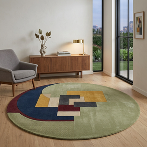 Lunette round wool rug in a mid-century living room with walnut sideboard and grey armchair